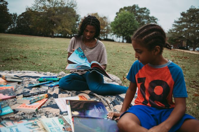 Kids reading books outside